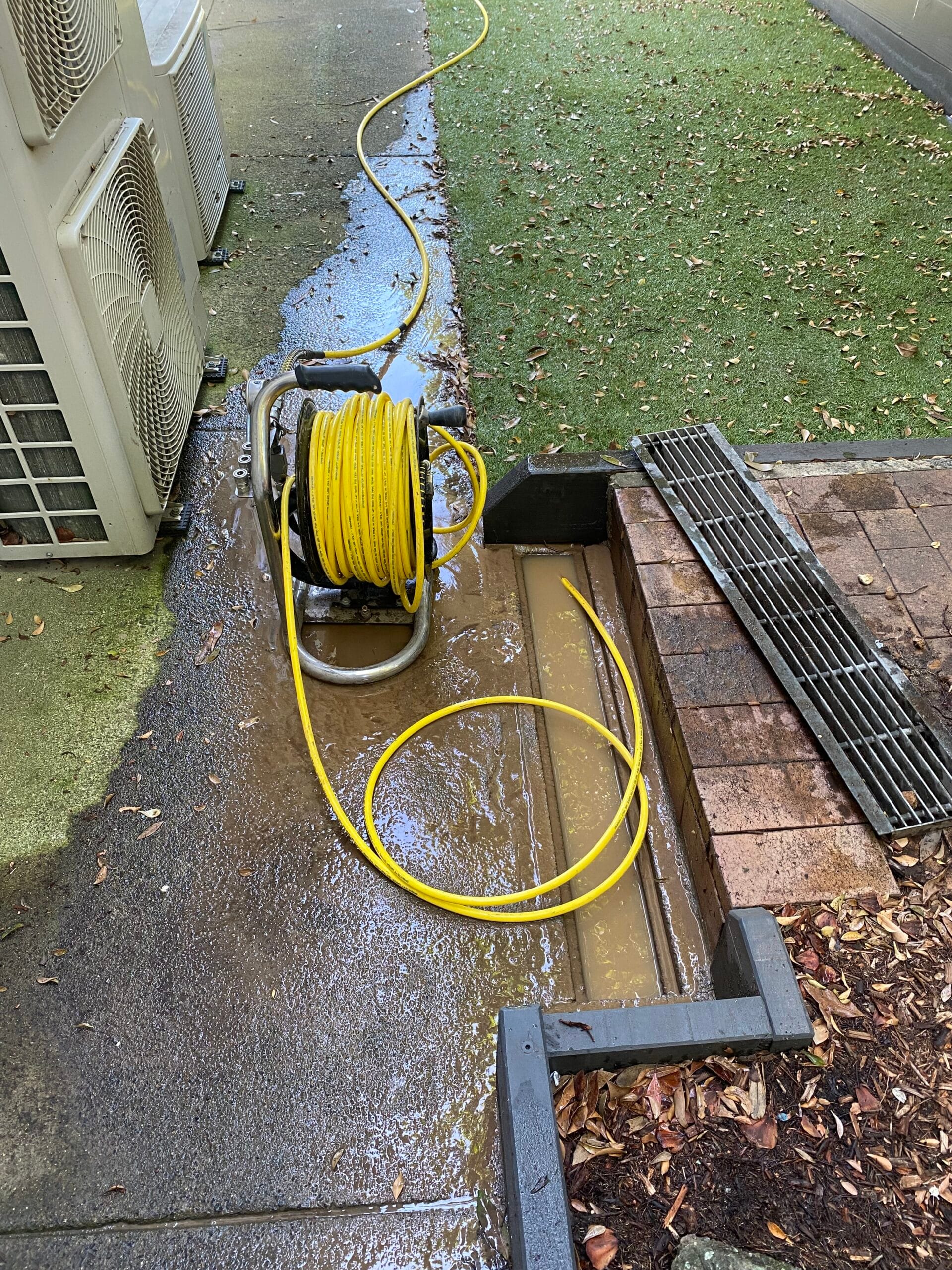 High-pressure drain cleaning equipment clearing a stormwater drain
