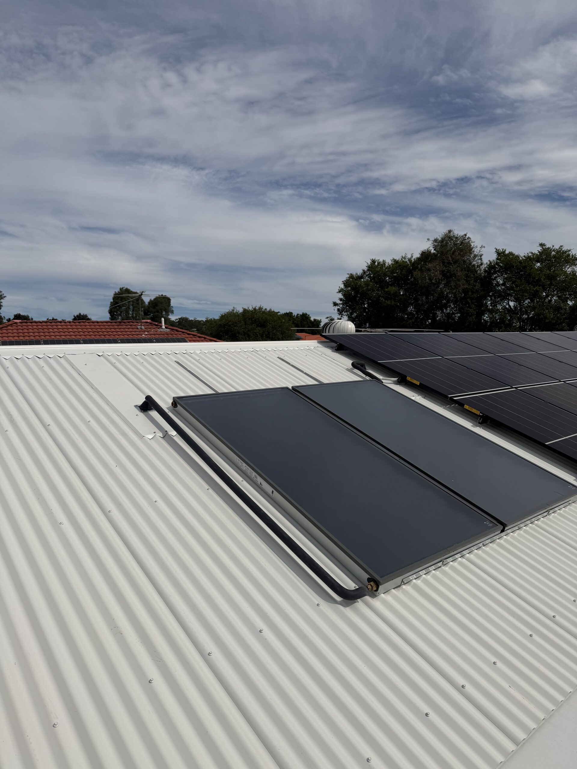 Roof-mounted solar hot water collectors installed on a Brisbane home