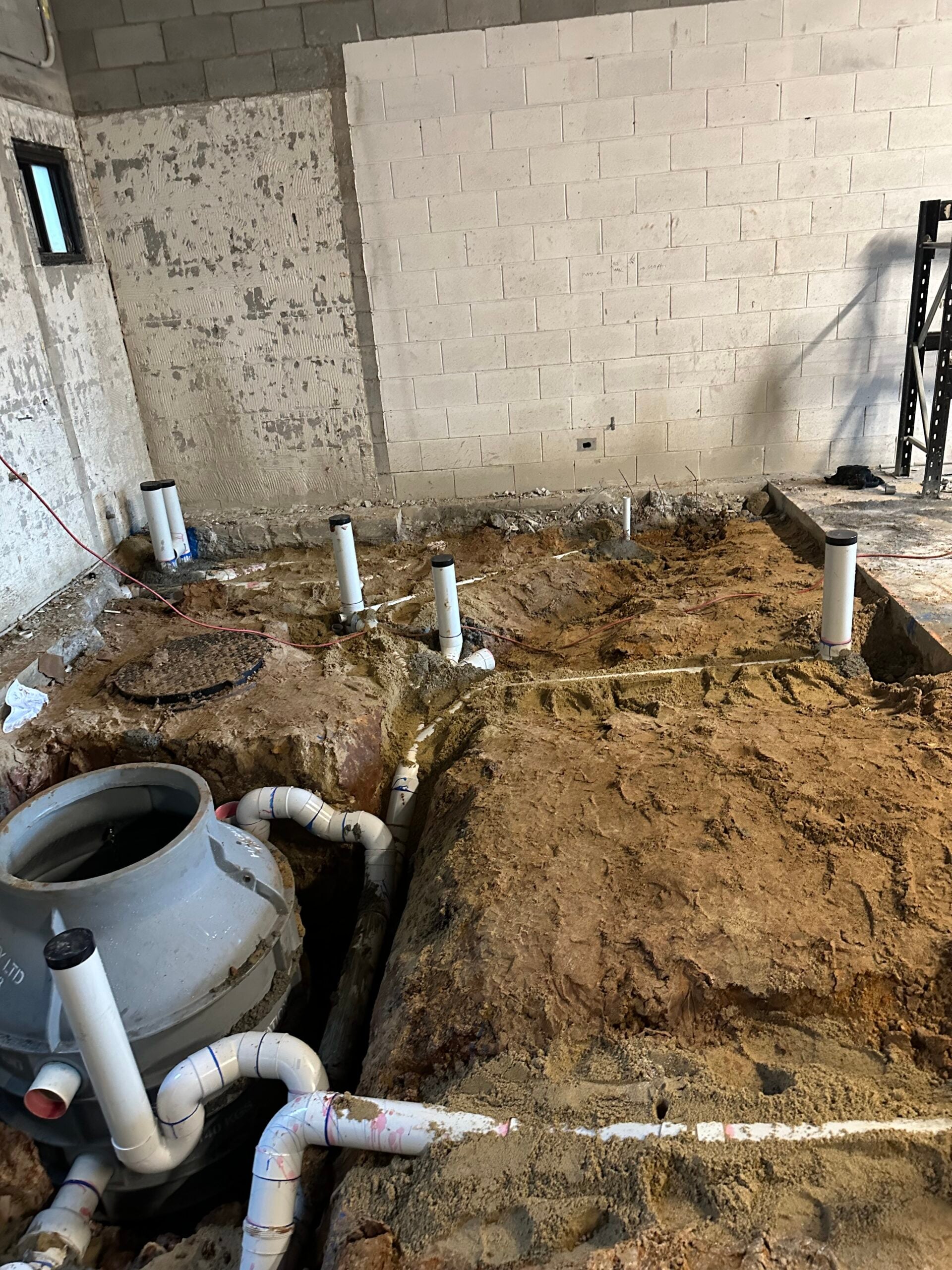 Plumbing and drainage rough-in during the Vikasati Gold Coast bathhouse fit-out